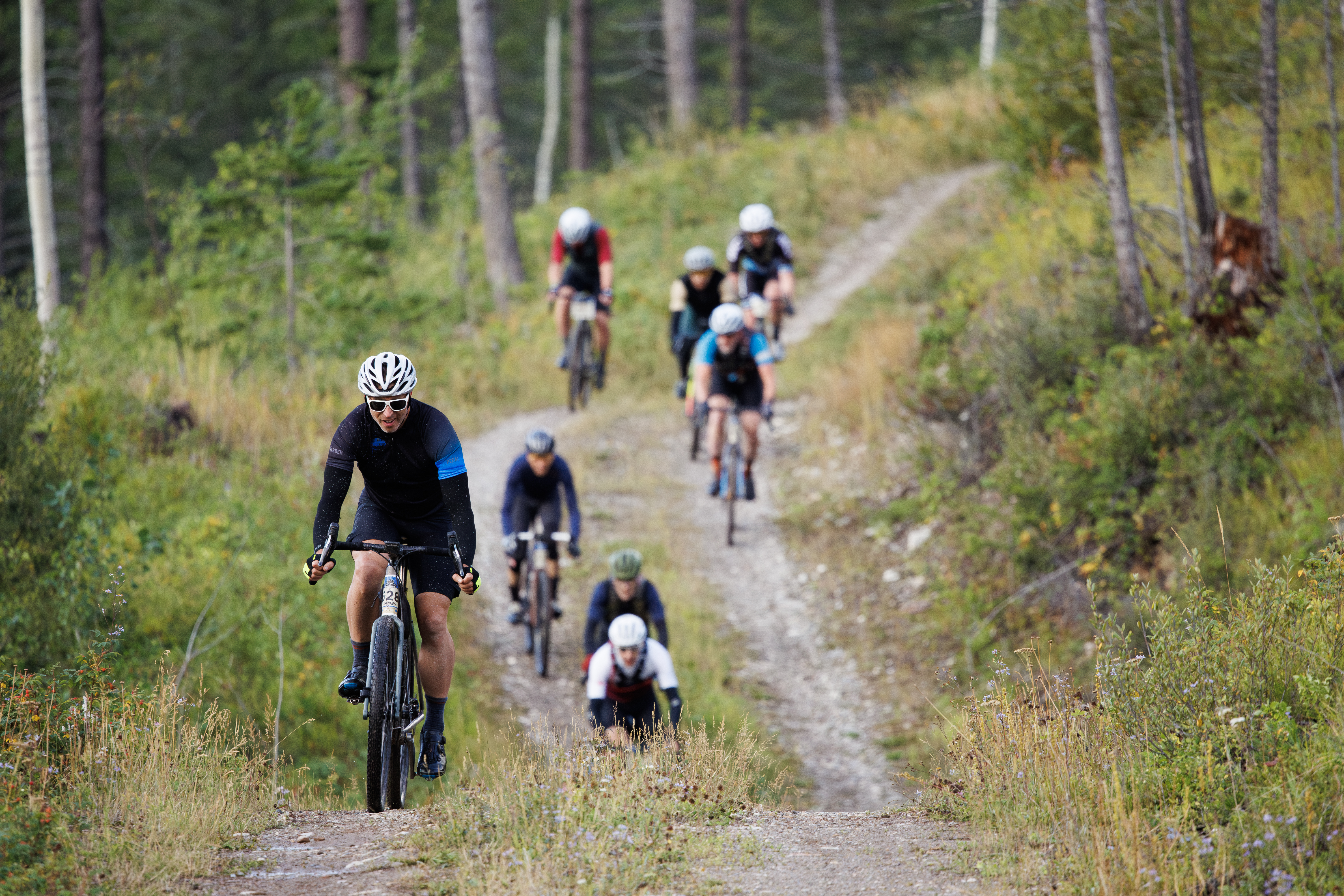 A group of men compete in the 2024 TransRockies Gravel Royale bike race in British Columbia, Canada. The Gravel Royale is a three-day stage race based out of Nipika Mountain Resort near Radium, British Columbia, Canada. The course takes the racers over a combination of gravel forestry and mining roads. (John Gibson Photo / GibsonPictures)