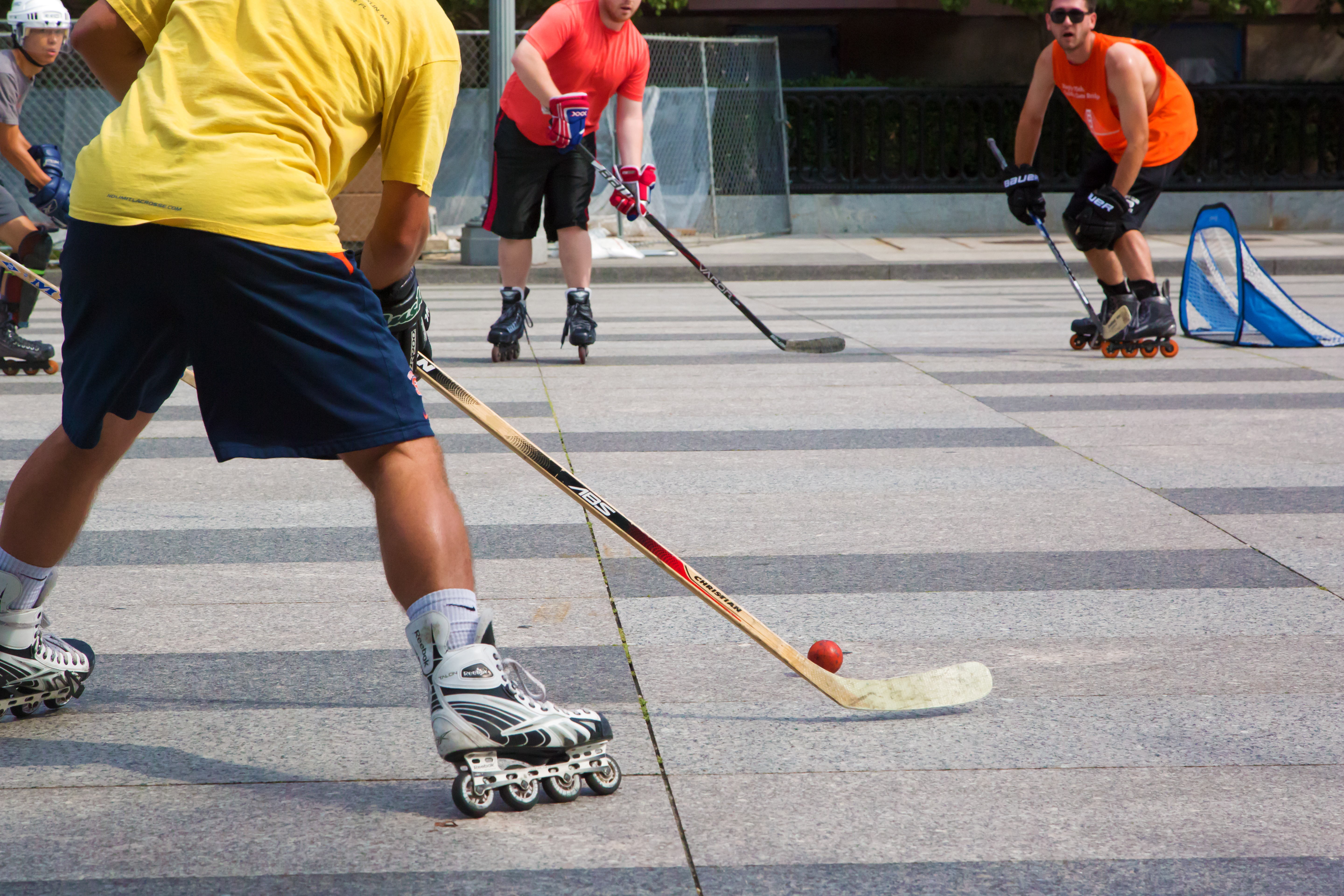 Washington  DC, USA - August 15, 2015: Young men play roller in-line hockey outdoor in downtown.