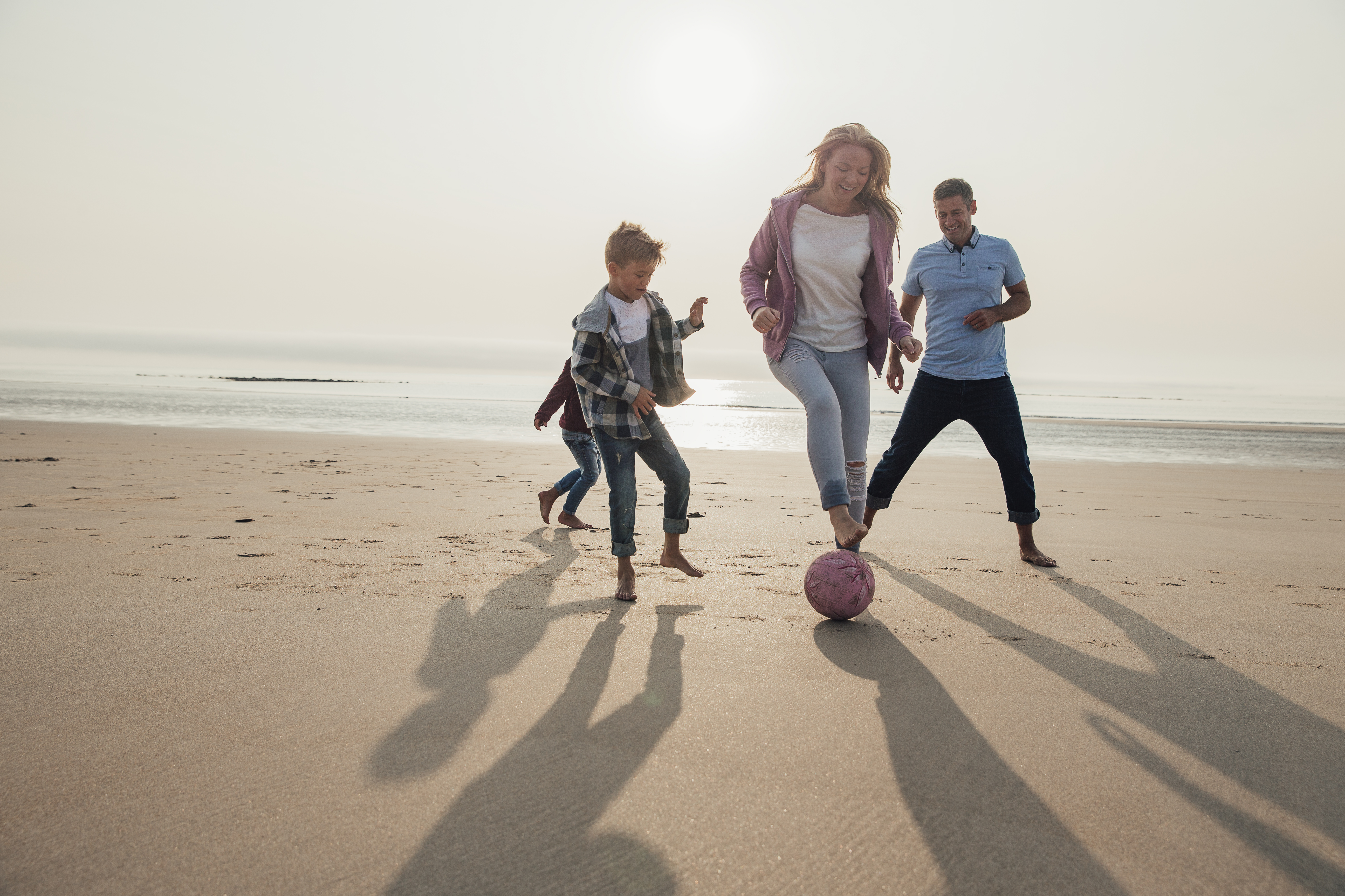 Gezin voetbalt op strand