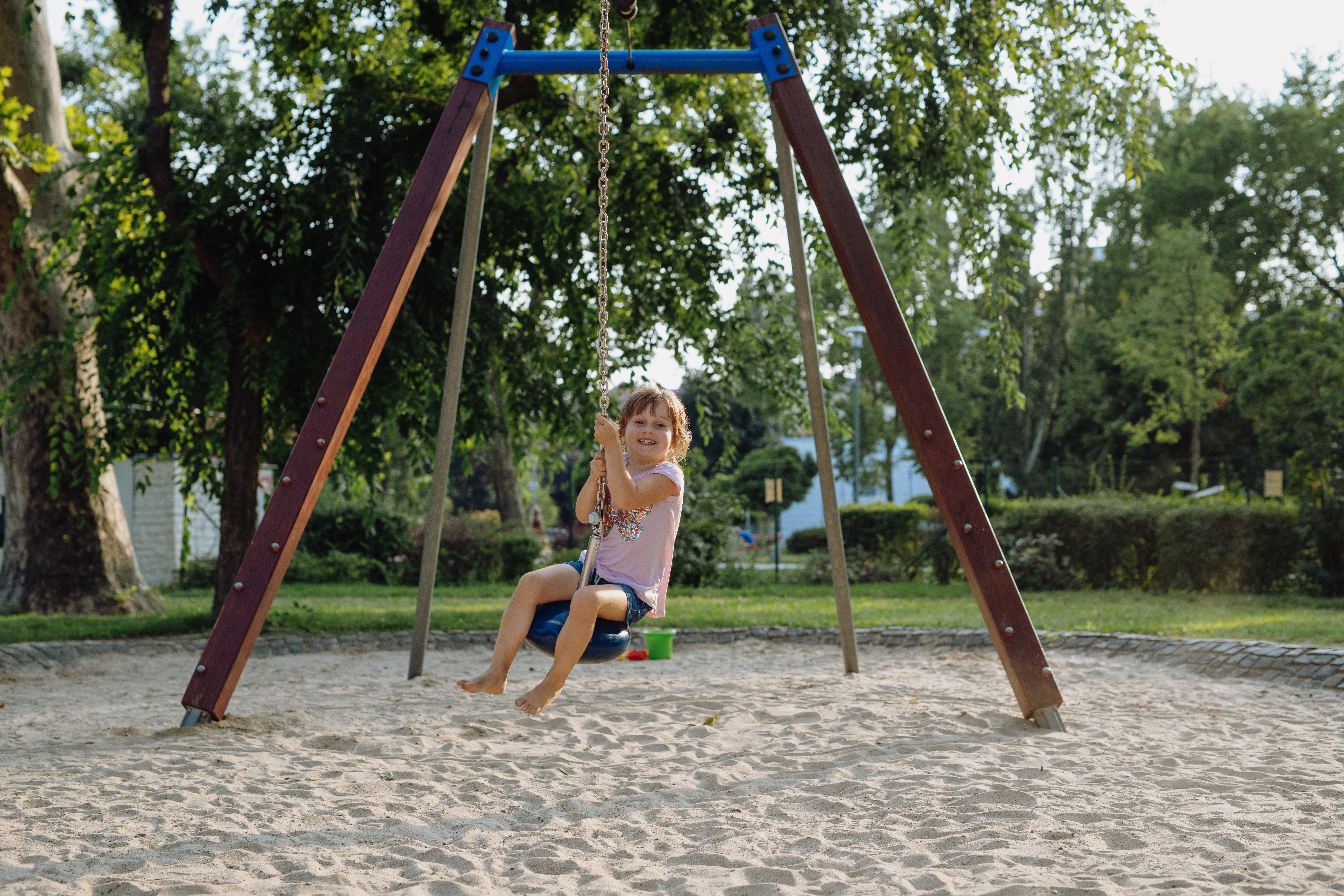 Girls playing outdoors on the swing