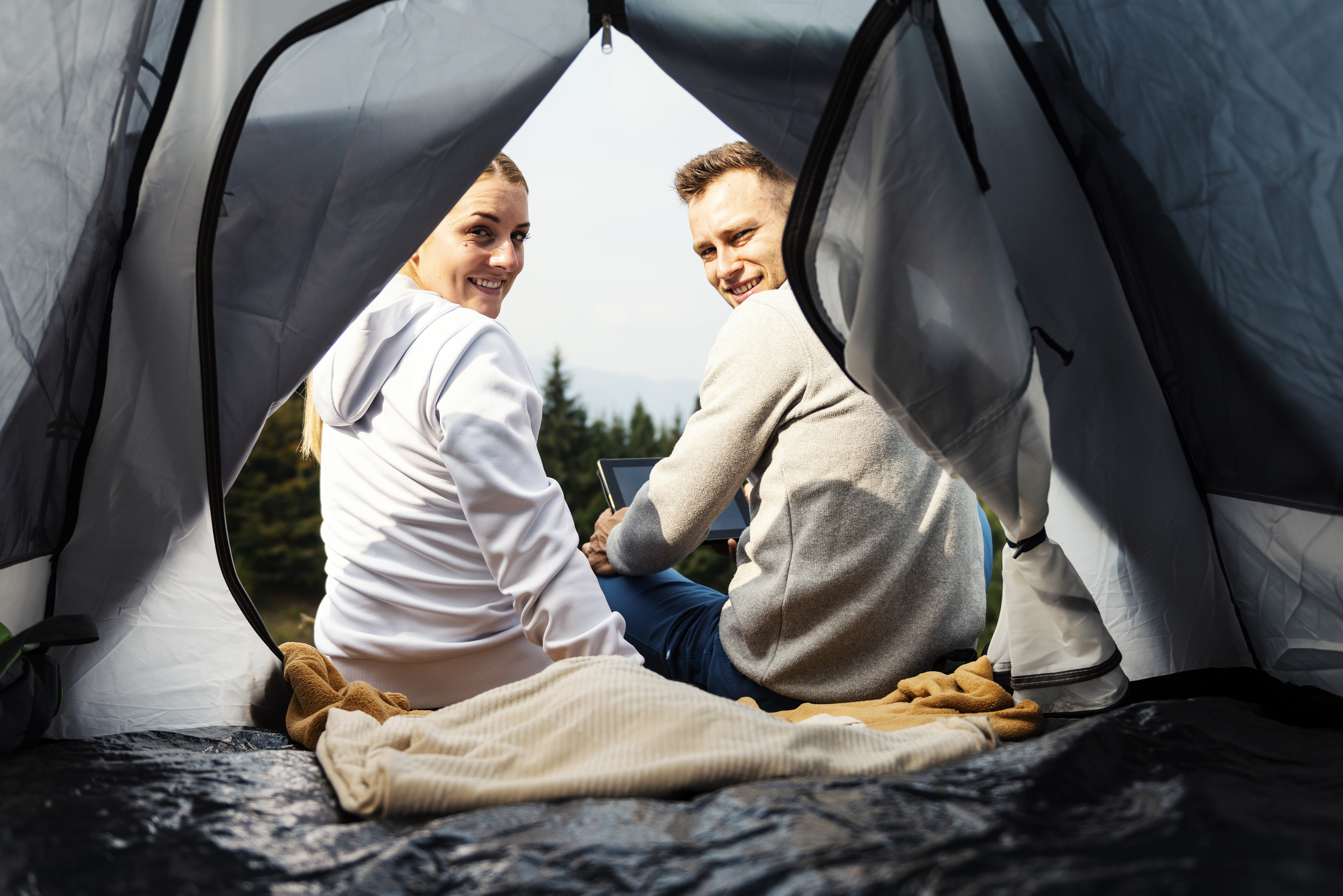 Campers with tablet in the mountain