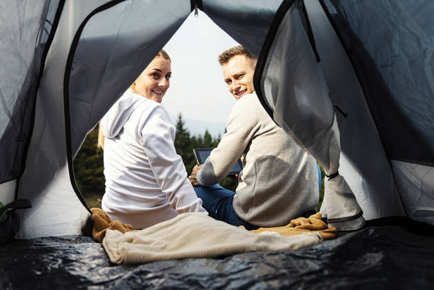 Campers with tablet in the mountain